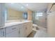Updated bathroom with granite countertop, large mirror, and a shower/tub combo at 5130 Brittany S Dr # 202, St Petersburg, FL 33715