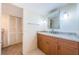 Well-lit bathroom with granite countertop vanity and a linen closet at 5130 Brittany S Dr # 202, St Petersburg, FL 33715