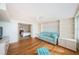 Sunlit living area featuring a light blue couch and built-in shelving at 5130 Brittany S Dr # 202, St Petersburg, FL 33715
