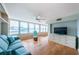 Spacious living room with built-in shelving and hardwood floors at 5130 Brittany S Dr # 202, St Petersburg, FL 33715