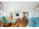 Bright living room with hardwood floors, comfy seating, and built in shelving at 5130 Brittany S Dr # 202, St Petersburg, FL 33715