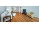 Open concept living room with hardwood floors and adjacent dining area at 5130 Brittany S Dr # 202, St Petersburg, FL 33715