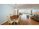 Open dining area with hardwood floors and view to living room at 5130 Brittany S Dr # 202, St Petersburg, FL 33715