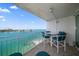Balcony with table and chairs offering stunning water views at 675 S Gulfview Blvd # 903, Clearwater Beach, FL 33767