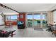 Living room with water views, TV, and access to balcony at 675 S Gulfview Blvd # 903, Clearwater Beach, FL 33767