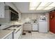 Bright kitchen features white appliances and light wood cabinets at 675 S Gulfview Blvd # 903, Clearwater Beach, FL 33767