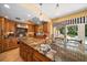 Spacious kitchen featuring granite countertops and custom wood cabinetry at 327 Lotus Path, Clearwater, FL 33756