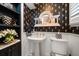 Stylish powder room with pedestal sink and elegant wallpaper at 327 Lotus Path, Clearwater, FL 33756
