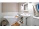 Elegant bathroom with freestanding tub, pedestal sink, and white wainscoting at 327 Lotus Path, Clearwater, FL 33756
