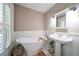 Bathroom featuring a white clawfoot tub, pedestal sink, and window with shutters at 327 Lotus Path, Clearwater, FL 33756