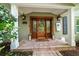 Ornate wooden front door with a welcoming wreath at 327 Lotus Path, Clearwater, FL 33756