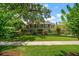 Two-story house with a large front yard at 327 Lotus Path, Clearwater, FL 33756