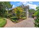 Charming two-story home with brick paver driveway and mature landscaping at 327 Lotus Path, Clearwater, FL 33756