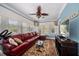 Sunroom features a comfortable sectional sofa and large windows at 327 Lotus Path, Clearwater, FL 33756