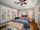 Bright bedroom with hardwood floors, plantation shutters, and a comfy bed at 327 Lotus Path, Clearwater, FL 33756