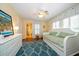 Charming bedroom with day bed, hardwood floors, and access to bathroom at 327 Lotus Path, Clearwater, FL 33756