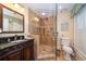Well-appointed bathroom with a walk-in shower and dark vanity at 327 Lotus Path, Clearwater, FL 33756