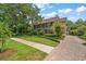 Beautiful home exterior with lush lawn and a brick paver driveway at 327 Lotus Path, Clearwater, FL 33756