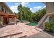 Inviting pool area with a large pool, stone patio, and lush tropical landscaping at 327 Lotus Path, Clearwater, FL 33756