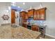 Kitchen with granite countertops and wood cabinets at 6420 Banyan Blvd # 303, New Port Richey, FL 34652