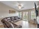 Relaxing living room features a sectional sofa and access to a balcony at 6420 Banyan Blvd # 303, New Port Richey, FL 34652