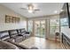 Relaxing living room with a large sectional sofa and access to a balcony at 6420 Banyan Blvd # 303, New Port Richey, FL 34652