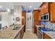 Kitchen boasts granite countertops, stainless steel appliances, and wood cabinets at 6420 Banyan Blvd # 303, New Port Richey, FL 34652