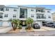 Two-story building with light teal exterior and attached garages at 6420 Banyan Blvd # 303, New Port Richey, FL 34652