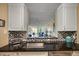 Modern kitchen with a breakfast bar and view to living room at 900 Cove Cay Dr # 1H, Clearwater, FL 33760