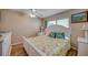 Bright bedroom with white bed, wood floors, and ceiling fan at 900 Cove Cay Dr # 1H, Clearwater, FL 33760