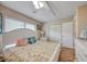 Bedroom with white bed, wood floors, and ceiling fan at 900 Cove Cay Dr # 1H, Clearwater, FL 33760