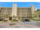 Condo building with parking and lush landscaping at 900 Cove Cay Dr # 1H, Clearwater, FL 33760