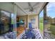 Sunroom with comfortable seating and sliding glass doors to the outdoors at 900 Cove Cay Dr # 1H, Clearwater, FL 33760