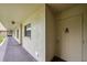 Residential hallway with light-beige walls and a door at 900 Cove Cay Dr # 1H, Clearwater, FL 33760