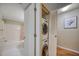Clean bathroom with a shower/tub combo and stackable washer/dryer at 900 Cove Cay Dr # 1H, Clearwater, FL 33760