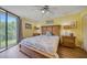 Main bedroom with king-size bed, nightstands, and access to a patio at 900 Cove Cay Dr # 1H, Clearwater, FL 33760