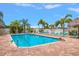 Refreshing pool with lounge chairs and a person enjoying the sun at 900 Cove Cay Dr # 1H, Clearwater, FL 33760