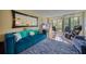 Bright living room with comfy seating, large TV, and sliding glass doors to balcony at 900 Cove Cay Dr # 1H, Clearwater, FL 33760