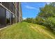 Building with grassy backyard, providing a serene outdoor space at 900 Cove Cay Dr # 1H, Clearwater, FL 33760