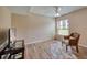 Living room with wood floors, a comfy chair, and large TV at 900 Cove Cay Dr # 1H, Clearwater, FL 33760