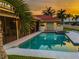 Inviting pool area with spa, screened enclosure, and sunset views at 4981 61St S Ave, St Petersburg, FL 33715