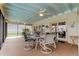 Spacious screened porch with seating area and ceiling fan at 4981 61St S Ave, St Petersburg, FL 33715