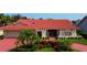 Single-story home with red tile roof, landscaping, and a paved driveway at 4981 61St S Ave, St Petersburg, FL 33715