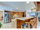 Kitchen with stainless steel appliances, wood cabinets, and breakfast bar at 4981 61St S Ave, St Petersburg, FL 33715