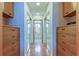 Large walk-in closet with built-in drawers and mirror doors at 4981 61St S Ave, St Petersburg, FL 33715