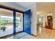 Bright entryway with blue door, tiled floor, and glimpses of living spaces at 4981 61St S Ave, St Petersburg, FL 33715