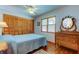 Cozy bedroom with double bed and wood dresser at 4981 61St S Ave, St Petersburg, FL 33715