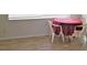 Small dining area with table and chairs, featuring light wood flooring at 4102 Darlington Rd, Holiday, FL 34691