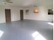 Spacious garage with light grey epoxy floor and two ceiling fans at 4102 Darlington Rd, Holiday, FL 34691