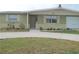 House exterior, showcasing a single-story home with a driveway and landscaping at 4102 Darlington Rd, Holiday, FL 34691